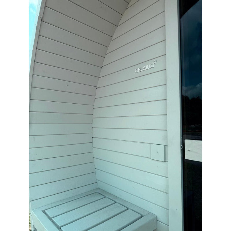 Close-up of the integrated bench in the entrance area of a white Celsium Joris Large Barrel Sauna